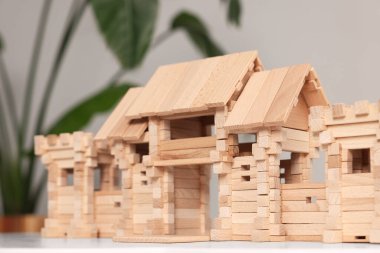 Tahta giriş kapısı beyaz masada bulanık arka planda, yakın plan. Çocuk oyuncağı.