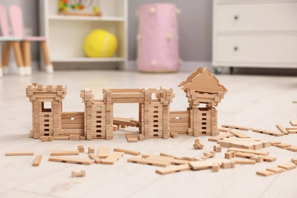 Wooden construction set on floor indoors. Children\'s toy