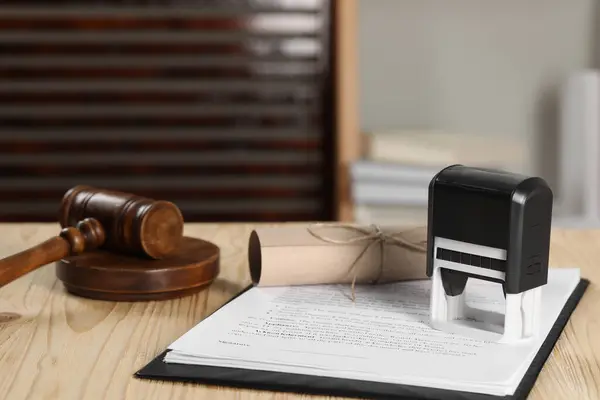 Notary contract. Documents, stamp and gavel on wooden table