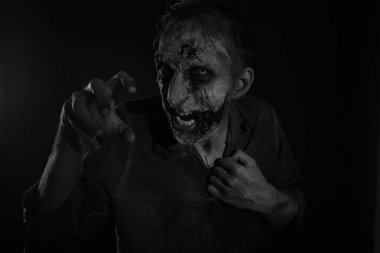 Karanlık arka planda korkunç bir zombi, siyah beyaz etkisi. Cadılar Bayramı canavarı