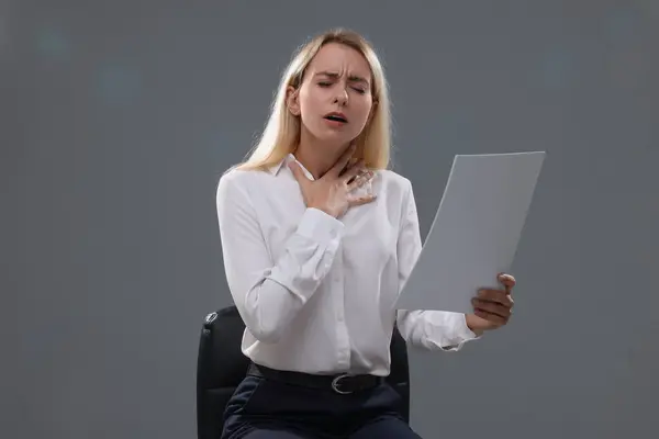 Casting call. Emotional woman with script performing against grey background