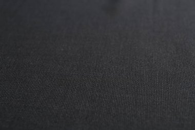 Arkaplan olarak koyu kumaşın dokusu, yakın plan