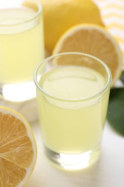 Lezzetli limonlu limonlu bardaklar ve limonlar, yakın plan.