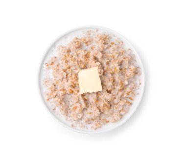 Süt ve tereyağlı lezzetli buğday lapası beyaz kasede izole edilmiş.