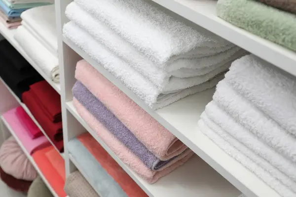 Bed linens and towels on shelves in shop
