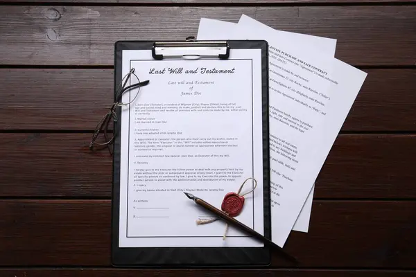 Last Will and Testament with wax seal, glasses and pen on wooden table, flat lay