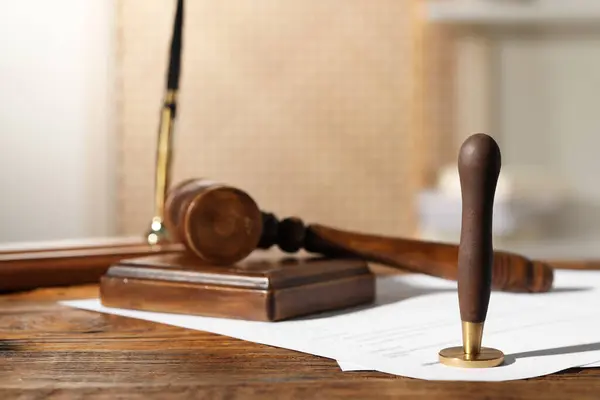 Notary contract. Wax stamp, document and gavel on wooden table