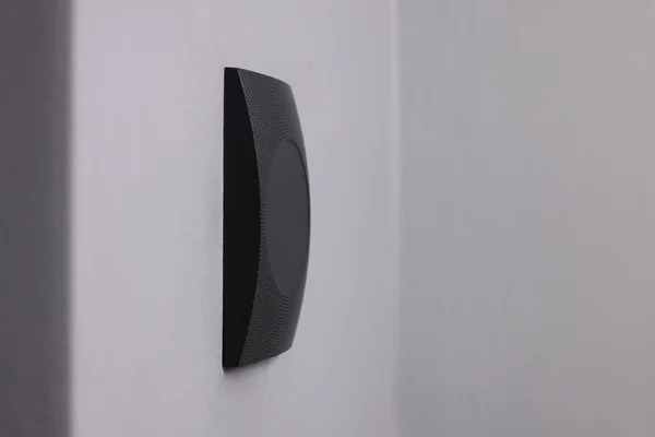 Magnetic door lock on grey wall, space for text. Home security