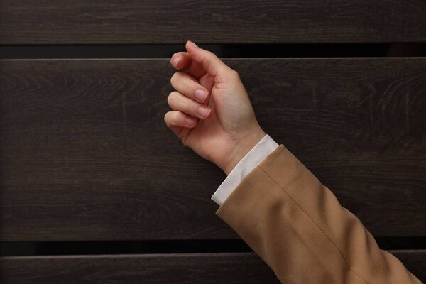 Collector knocking on door indoors, closeup. Space for text