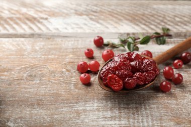 Kaşıkla kurutulmuş yaban mersini ve kırsal ahşap masada taze yaban mersini. Metin için boşluk