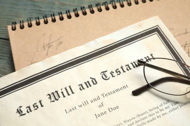 Last Will and Testament, notebook and glasses on rustic wooden table, closeup clipart