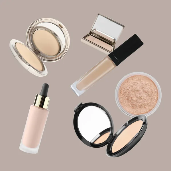 Face powders and other makeup products falling on beige background