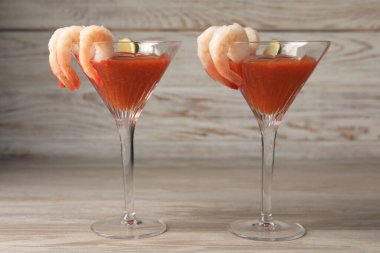 Ahşap masada soslu ve limonlu lezzetli karides kokteyli.