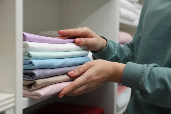 Customer choosing bed linens in shop, closeup