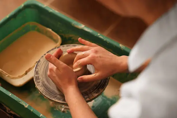 Clay crafting. Woman making bowl on potter\'s wheel, closeup