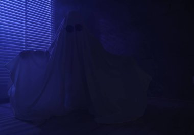 Ürkütücü hayalet. Pencerenin yanında, mavi ışıkla kaplanmış kadın.