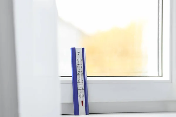Weather thermometer on window sill indoors. Space for text