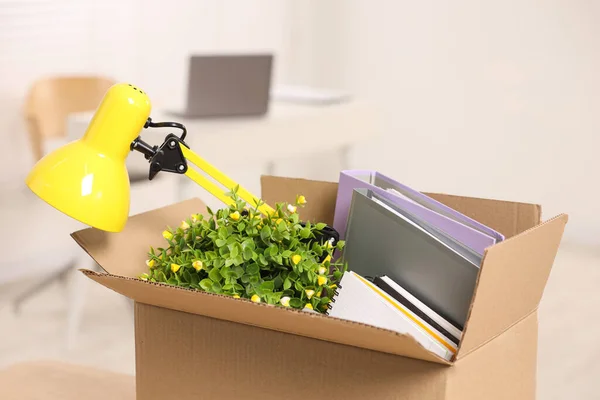 Unemployment problem. Box with worker\'s personal belongings in office
