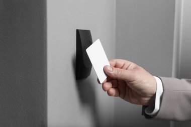 Manyetik kapı kilidini anahtar kartıyla açan adam, yakın plan. Ev güvenliği
