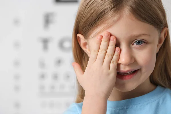 Menina Cobrindo Seu Olho Contra Gráfico Teste Visão — Fotografia de Stock