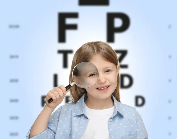 Vision test. Little girl with magnifying glass and eye chart on gradient background
