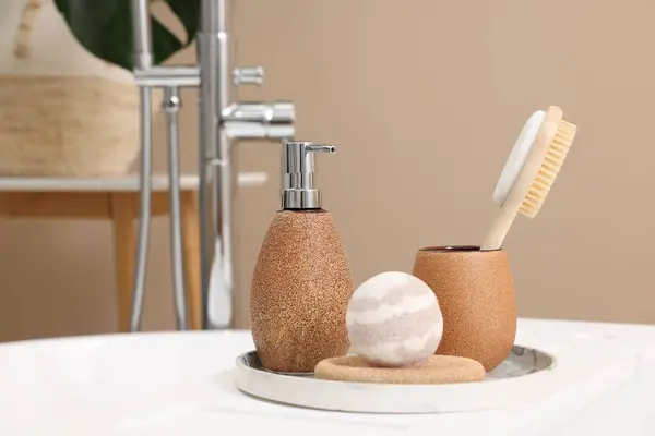 Different personal care products and accessories on bath tub in bathroom, closeup