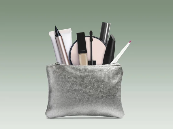 Cosmetic bag filled with makeup products on color gradient background
