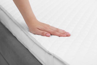 Beyaz yumuşak şilteye dokunan kadın, yakın çekim manzaralı.