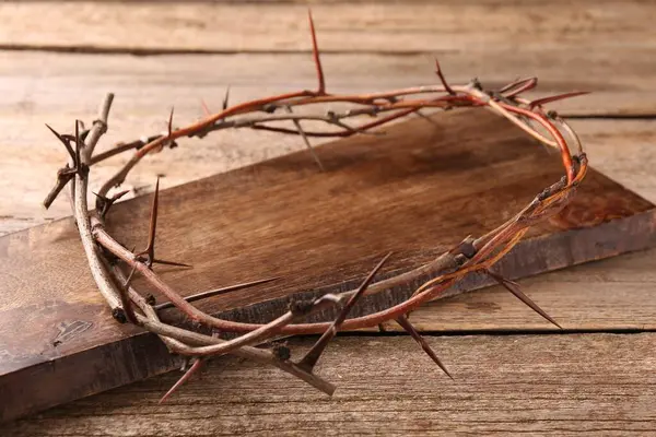 Crown of thorns on wooden table, closeup