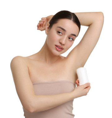 Güzel bir kadın beyaz arka plana deodorant sürüyor.