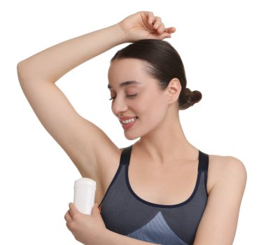 Güzel bir kadın beyaz arka plana deodorant sürüyor.