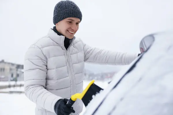 Człowiek Czyszczący Śnieg Samochodu Szczotką Zewnątrz — Zdjęcie stockowe