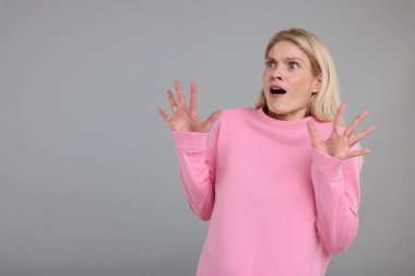 Gri arkaplanda şaşırmış kadının portresi, metin için boşluk