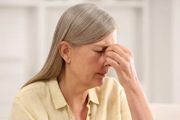 stock image Menopause. Woman suffering from headache at home