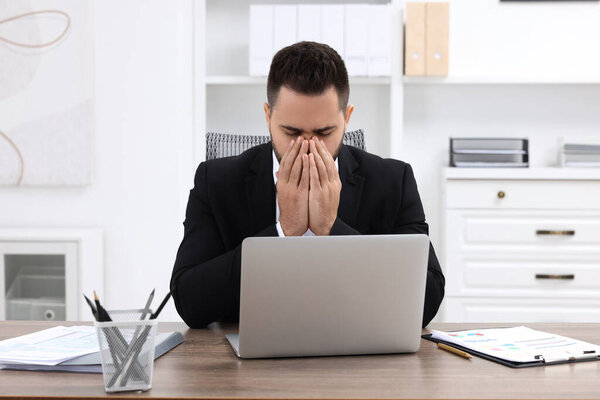 Sick man coughing at workplace in office