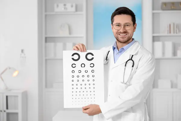 Ophthalmologist with vision test chart in clinic, space for text