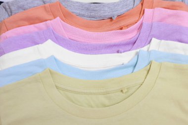 Arka plan ve üst görünüm olarak birçok üst üste dizilmiş kıyafet