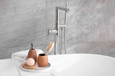 Banyodaki küvette farklı kişisel bakım ürünleri ve aksesuarlar.