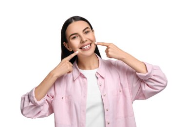 Temiz dişleri olan güzel bir kadın beyaz arka planda gülümsüyor.