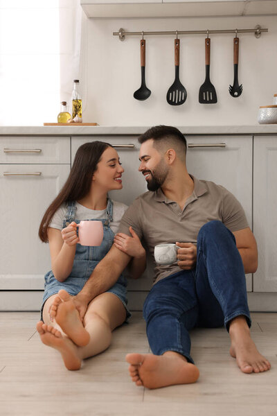 Affectionate young couple spending time together in kitchen