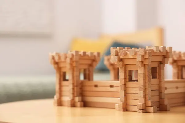 Wooden fortress on table indoors, space for text. Children\'s toy