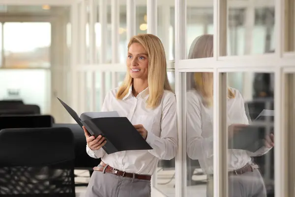 Smiling woman with folder in office. Lawyer, businesswoman, accountant or manager