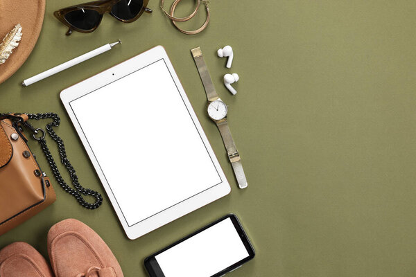 Flat lay composition with modern tablet on olive background. Space for text