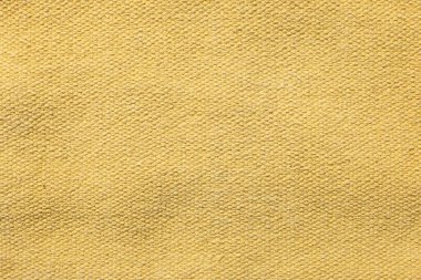 Arka plan olarak yumuşak sarı kumaşın dokusu, üst görünüm