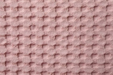 Arka plan olarak pembe örülmüş kumaş dokusu, üst görünüm