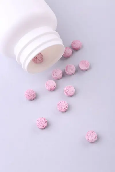 Jar with vitamin pills on white background, flat lay