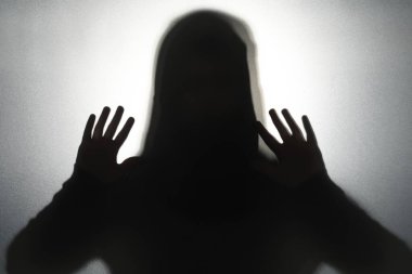 Camların arkasındaki hayalet silueti gri arka planda