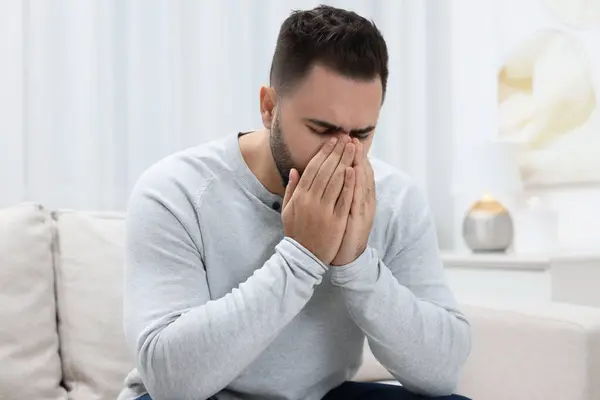 Sick man coughing at home. Cold symptoms