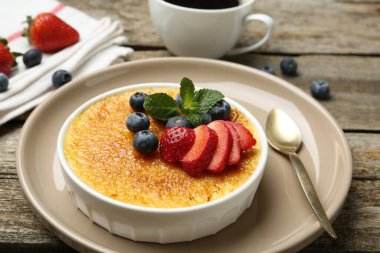 Böğürtlenli ve nane şekerli nefis creme brulee ahşap masada, yakın plan