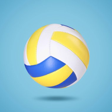 Açık mavi arka planda havada bir voleybol topu